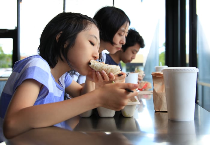 A family eating Tex-Mex food at a restaurant.