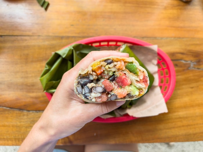 eating a burrito with left hand.