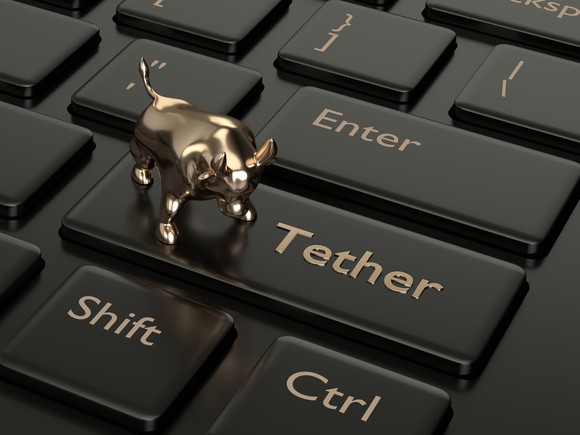 Gold bull on top of a Tether keyboard button.