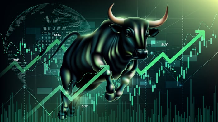 A green bull jumping over a green arrow and stock chart.