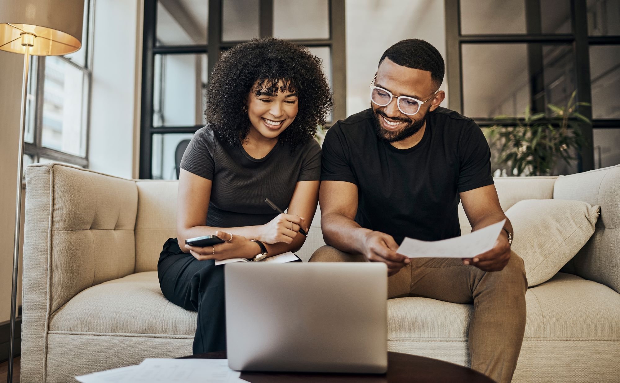 A happy couple looking at their computer.