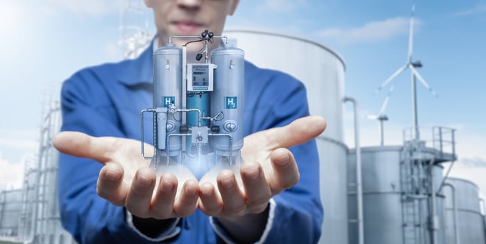 A person holding a hydrogen refueling station.