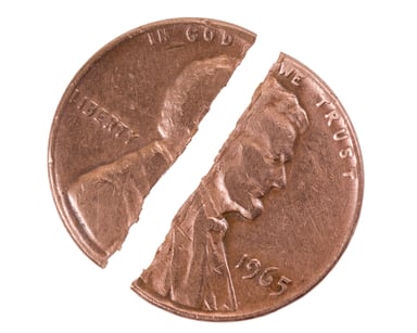 A U.S. penny being cut in half. 