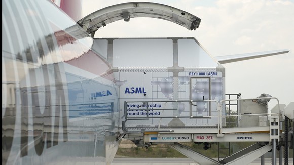 An airplane cargo area with ASML's logo.