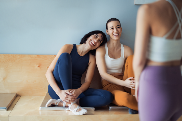 People smile while wearing yoga pants.