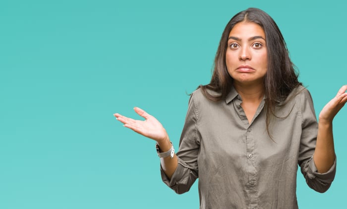 Skeptical-looking person shrugging.