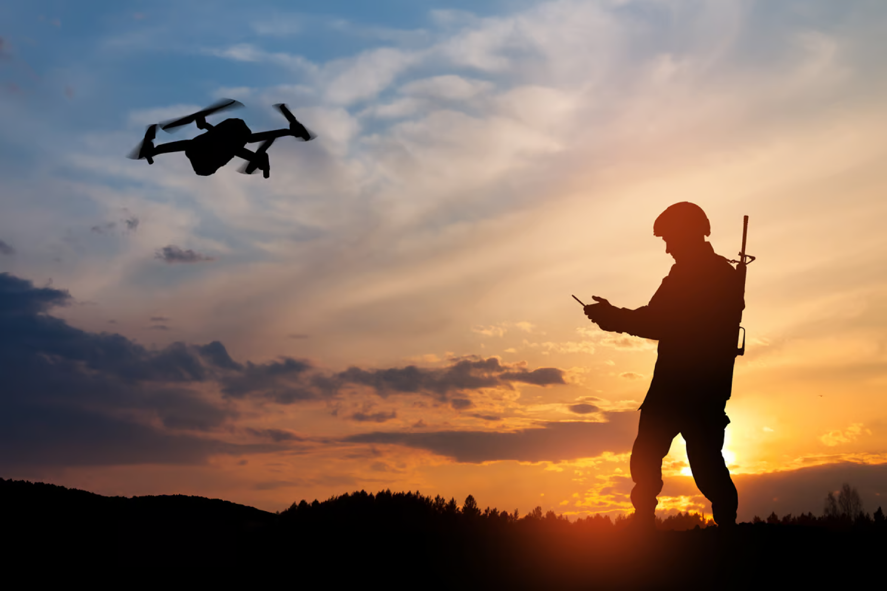 Military personnel controlling a flying drone.