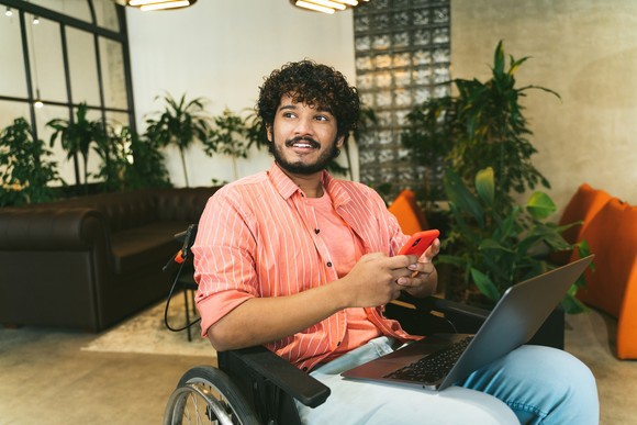 A person with a laptop and a smartphone.