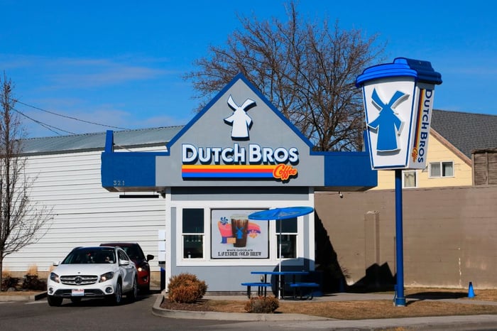 Dutch Bros location with cars parked in front.