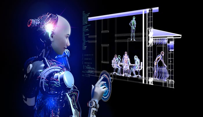A humanoid robot touching a screen with computerized figures.