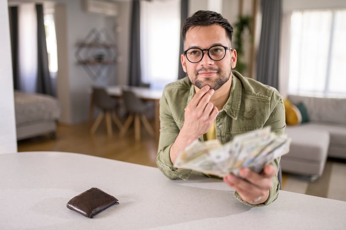 Someone holding money fanned out.