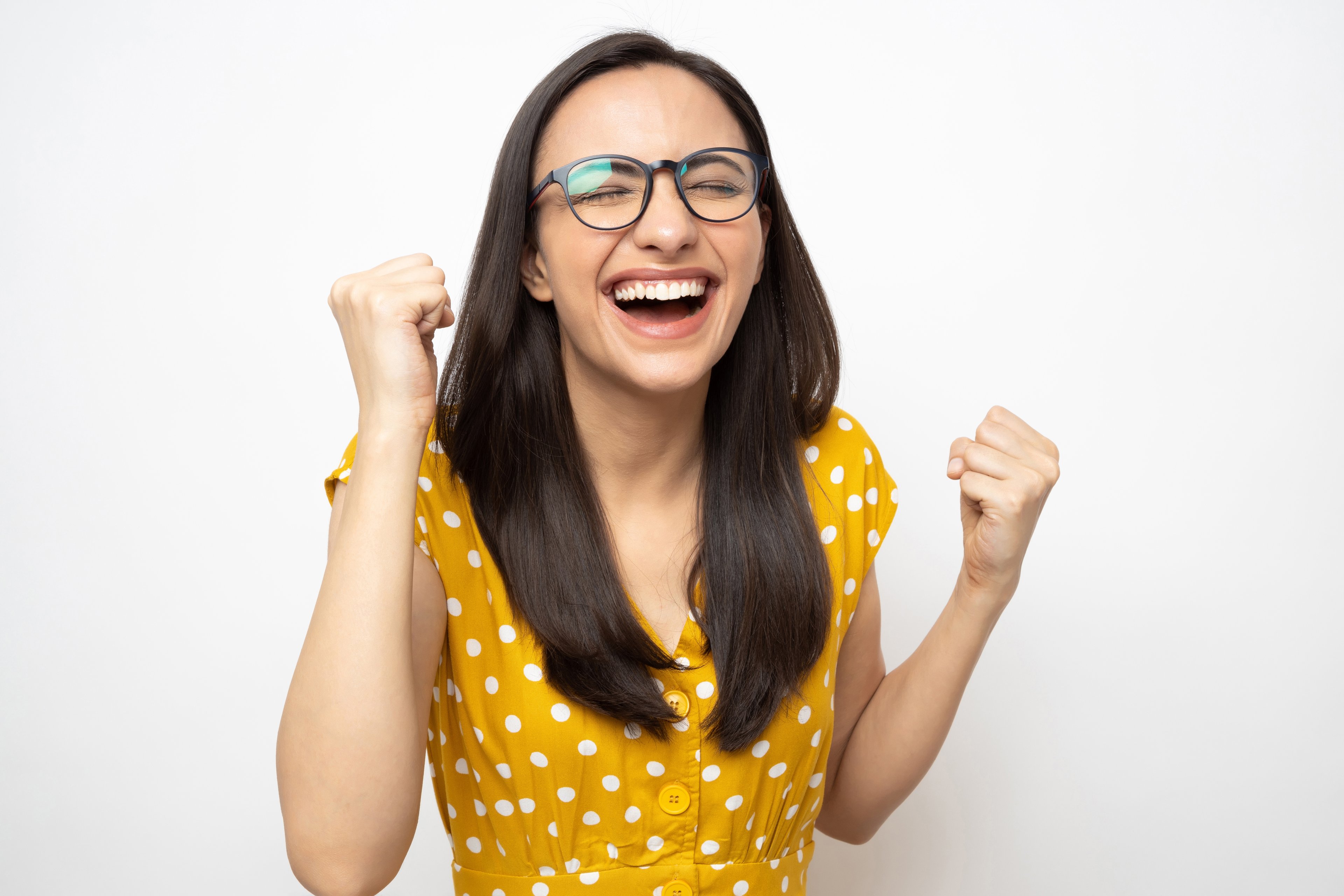 Getty - happy smiling fist pumping yellow dress