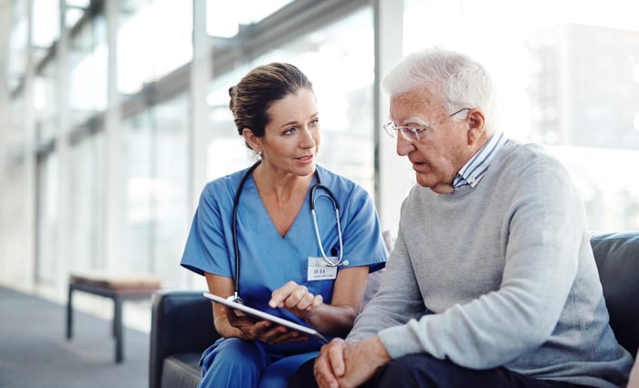 Doctor reviewing notes with a patient.