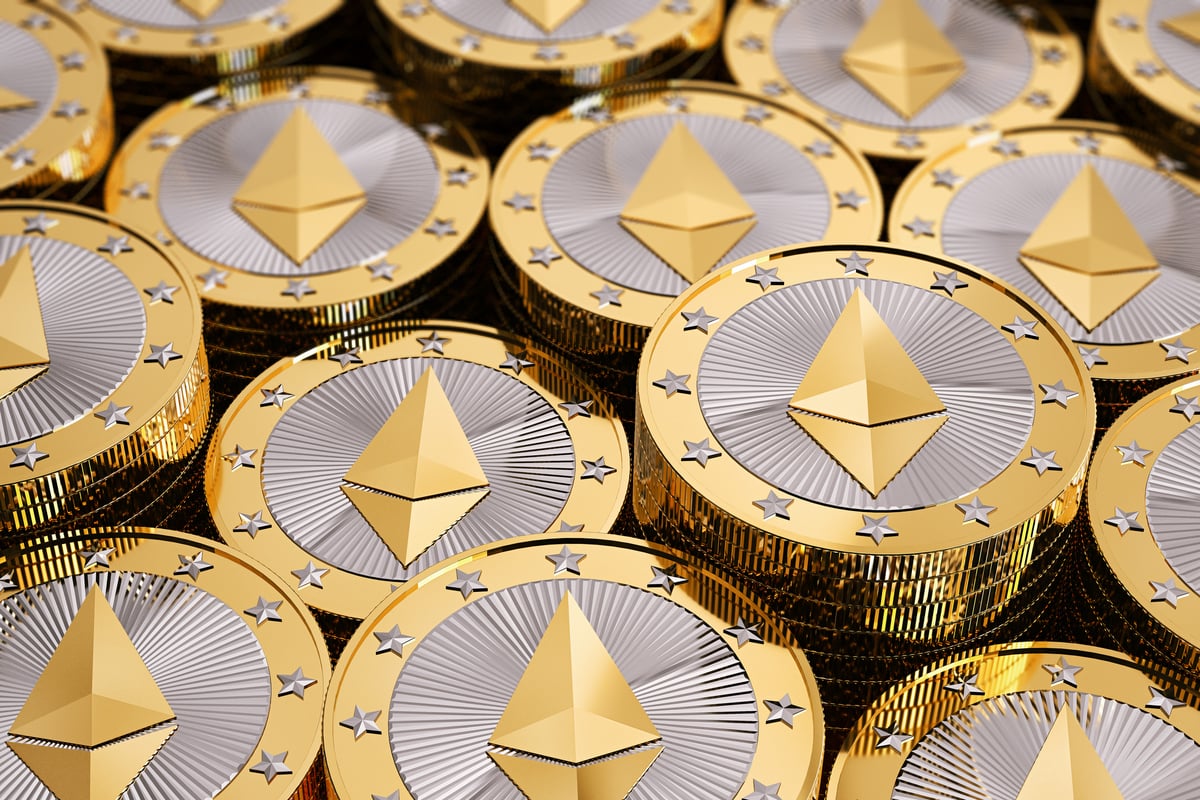 A large pile of gold coins embossed with the Ethereum logo.