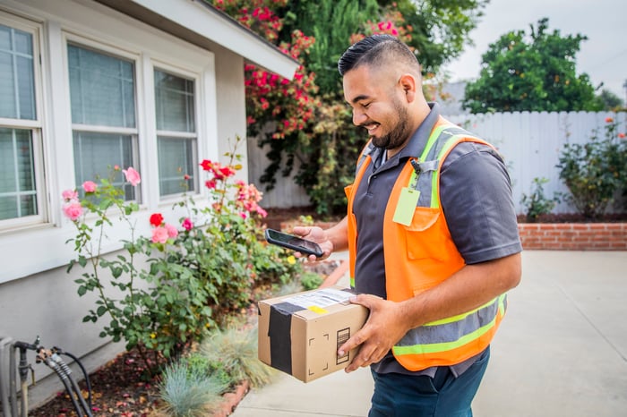 A delivery person dropping off a package. 