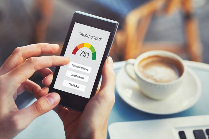 Person checking credit score on a phone.