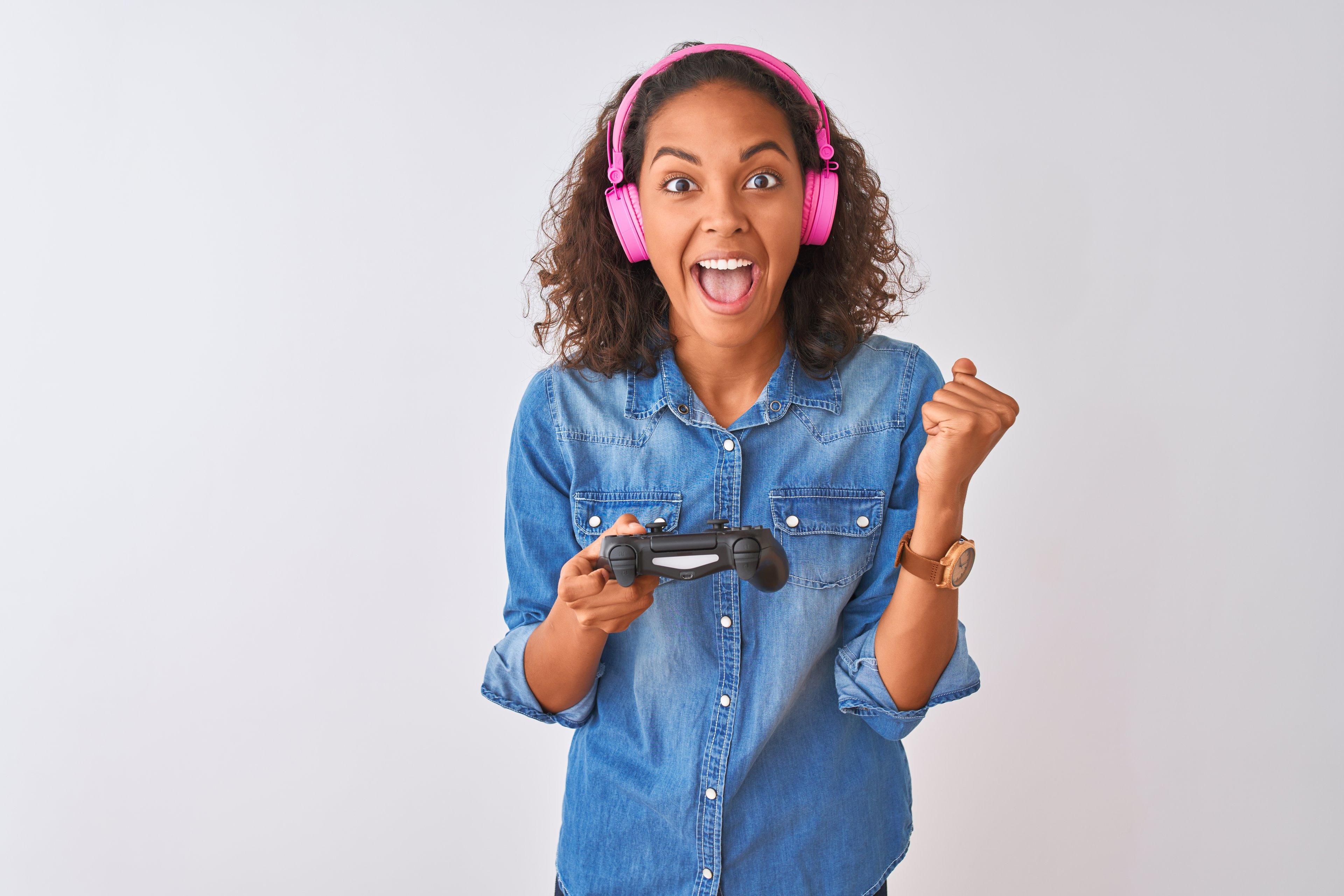 A person wears headphones and holds a video game controller.