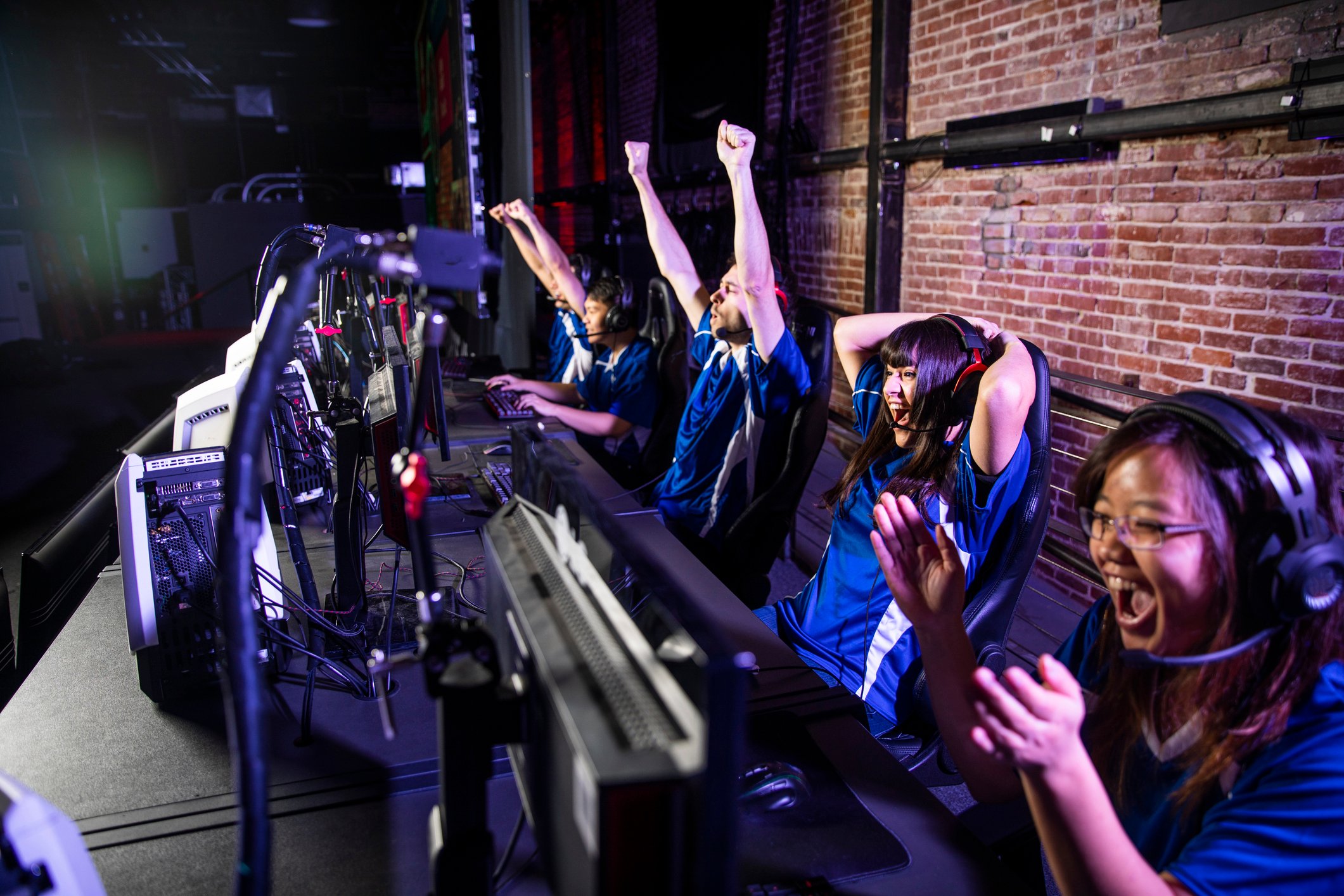 Team of videogamers cheering.