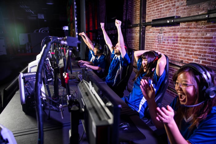 Team of videogamers cheering.