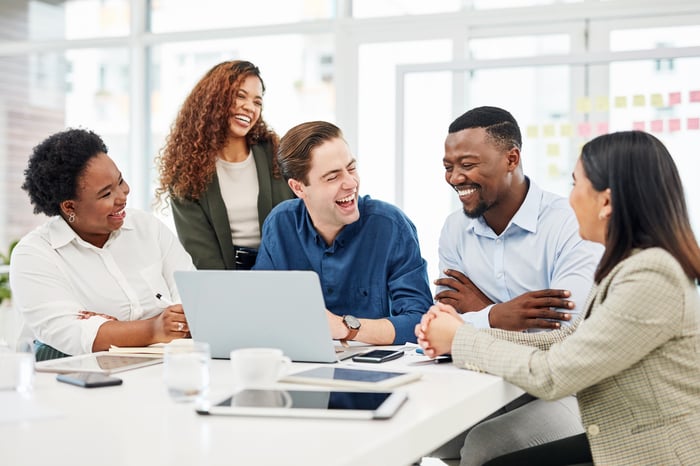 Group of people discussing stocks.