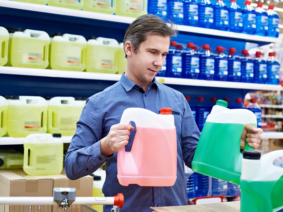 Person comparing products at an automotive parts store.