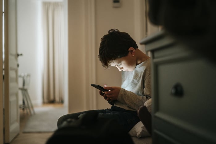 A person uses social media on a smartphone.