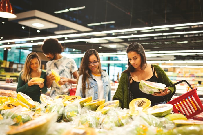 Smiling people shopping for groceries.