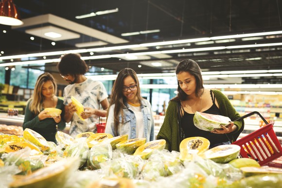 Smiling people shopping for groceries.
