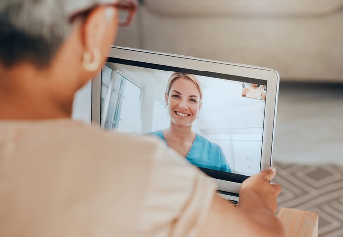 Two people participating in a telehealth session.
