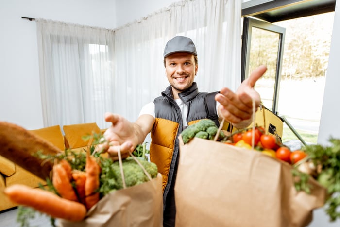 A person delivering groceries.