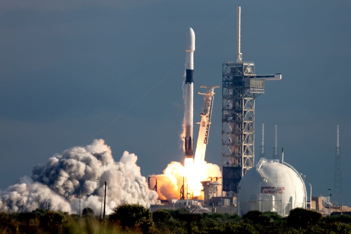 A rocket blasts off from a launch pad.