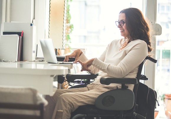 Person working at desk smiling.