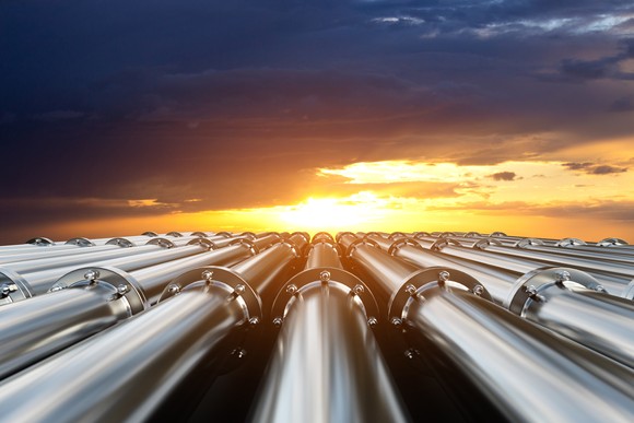 A view of natural gas pipelines at sunset.