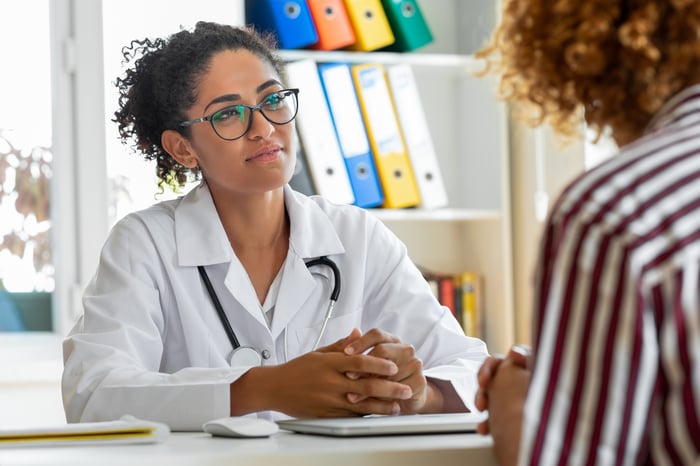 Physician talking to patient.