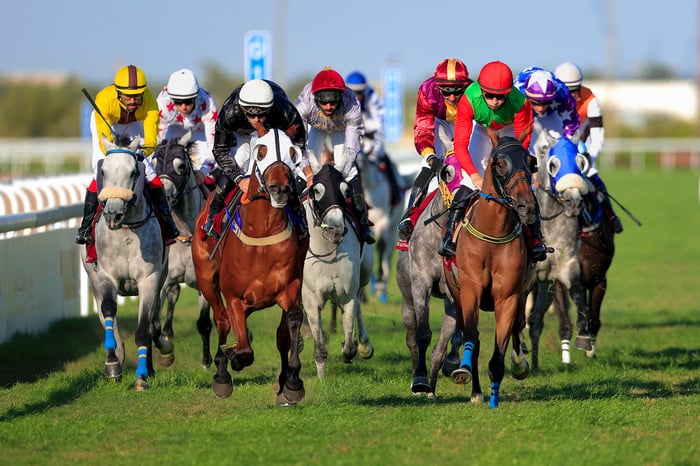 Jockeys ride horses during a race.
