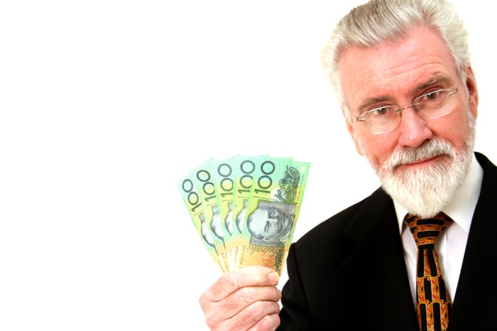 Person holding up money.