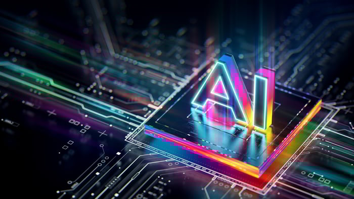 A circuit board with a processor. 3D letters AI rendered on top of the chip.