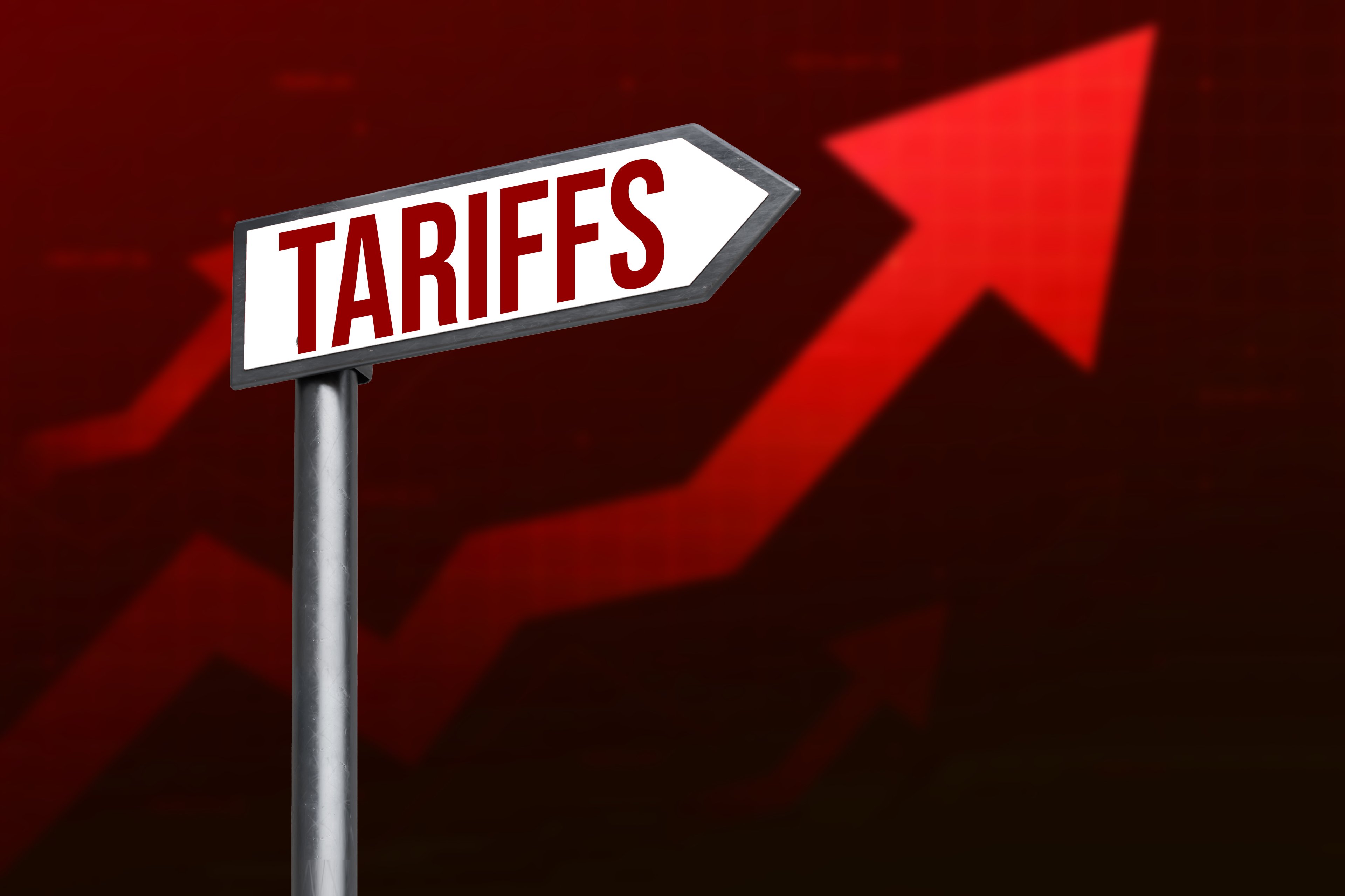A sign that says tariffs with a red arrow pointing up. 