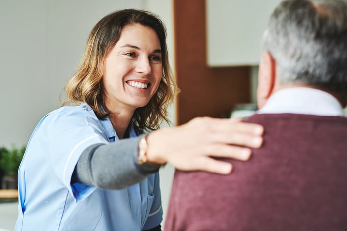 A medical professional talking to a patient. 