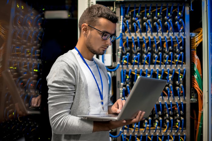 A  person with a laptop in a technology lab.