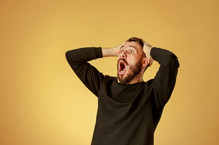 A person holding their head in shock.