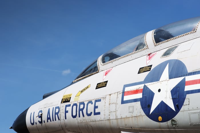U.S. Air Force jet fighter cockpit against sky.