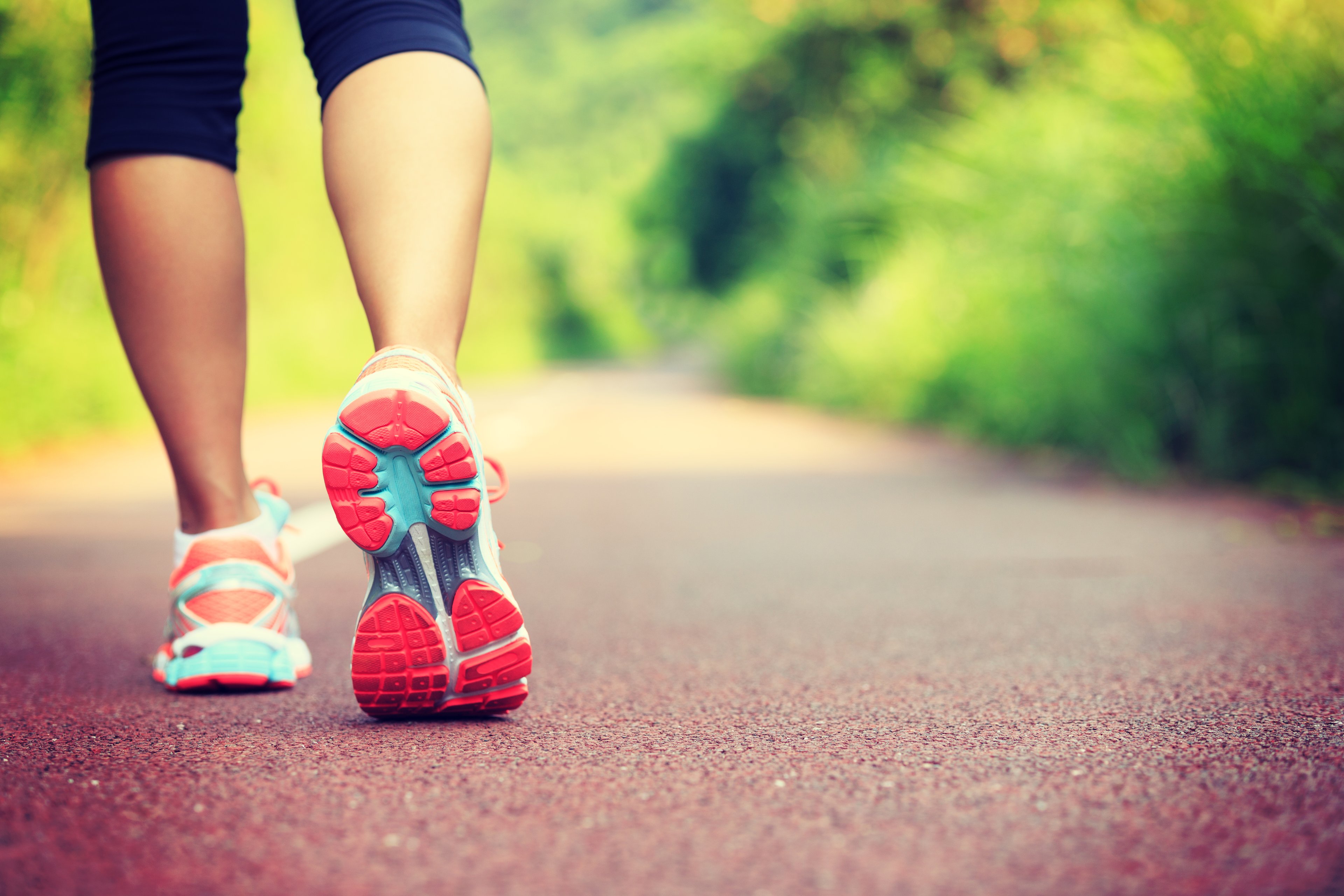 sneaker of woman running on path