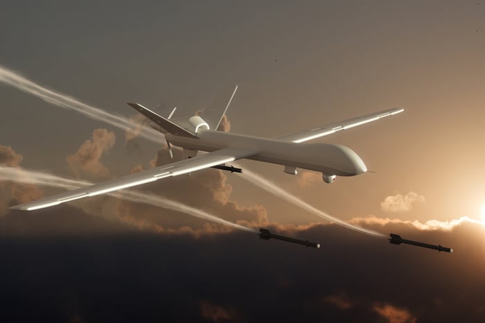 A drone fires missiles in the sky. 