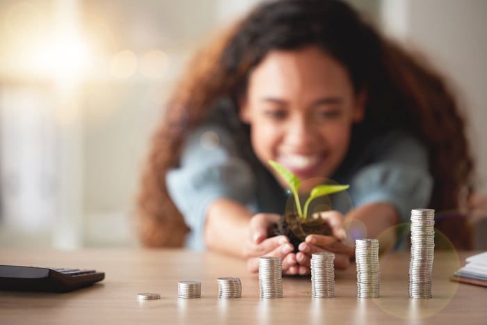 A person watching coin piles grow.