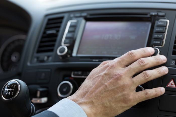 A person listening to the radio in their car.