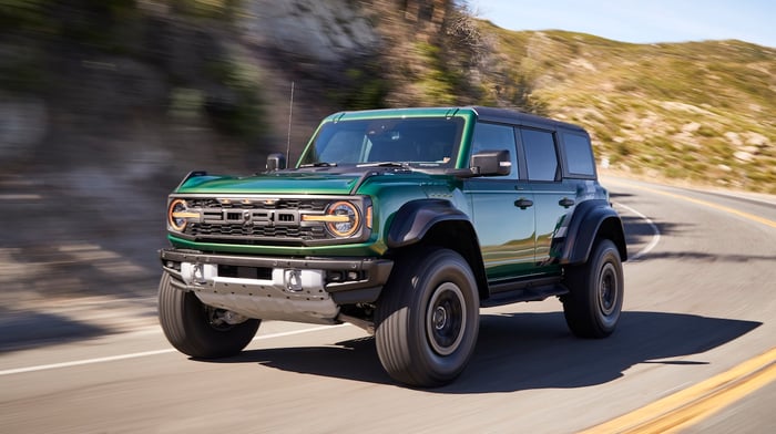 A green SUV on the road.