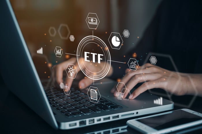 hands typing on keyboard with ETF sign.