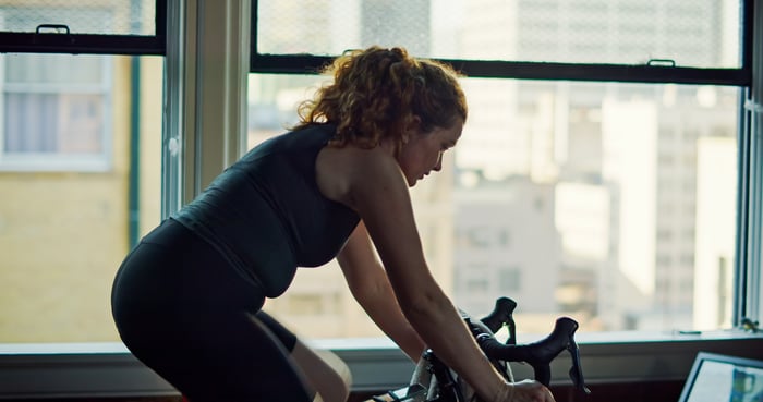 Person using an exercise bike.