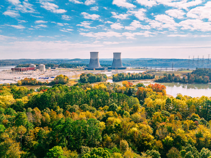 An elevated view of tall cooling towers of a nuclear power plant on a sunny Autumn day.